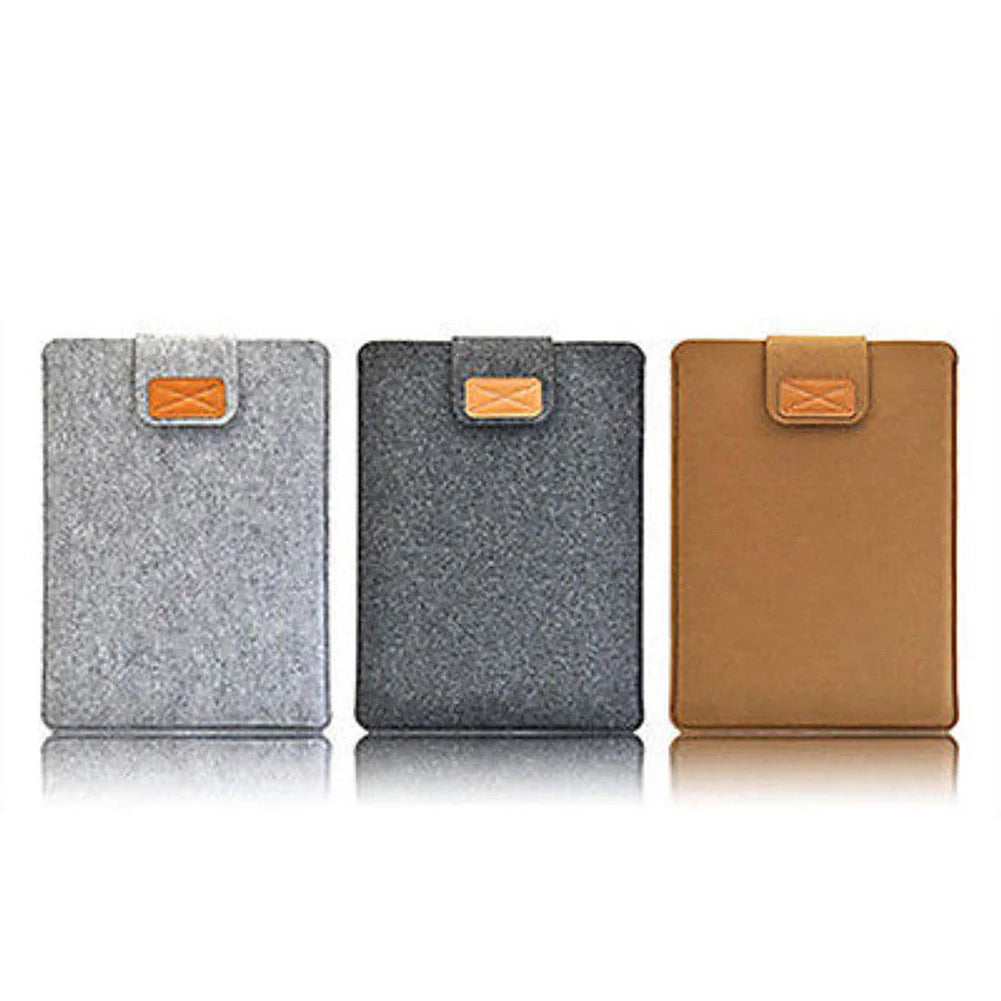 Three felt laptop sleeves in silver, gray, and brown with leather tabs.