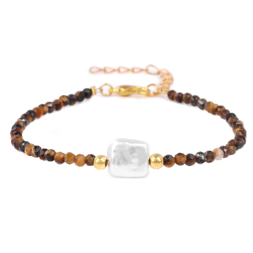 A natural stone bead bracelet featuring brown and amber beads and a clear white stone with a gold lace-up closure.