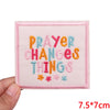 Pink embroidered patch with colorful letters spelling out PRAYER CHANGES THINGS