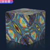 A cube with a swirling, iridescent pattern is shown on a dark surface.