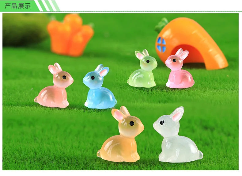 A set of cute resin miniature bunny figurines in various pastel colors sitting on green grass.