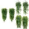 Multiple arrangements of artificial green hanging vines used for indoor and outdoor decor.