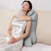 A woman is lying down, resting her head on an ergonomic memory foam wedge pillow while reading.