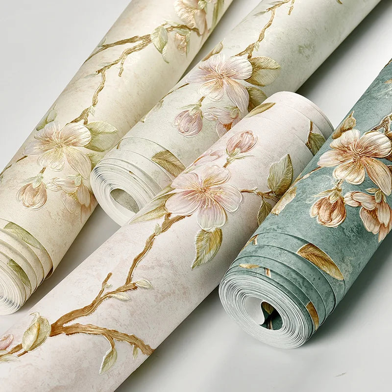 Rolls of 3D embossed floral self-adhesive wallpaper in soft green and beige tones.