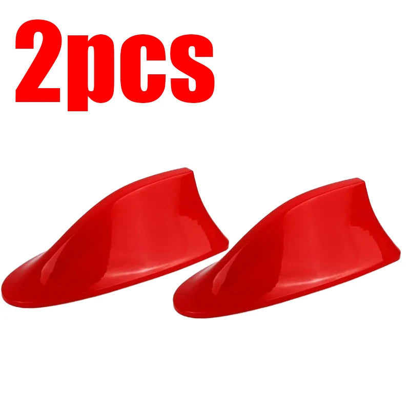 Two red shark fin car antennas for FM/AM signal enhancement