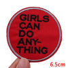 Red embroidered patch with black text that reads Girls can do anything