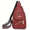 A maroon PU leather crossbody bag with a black adjustable strap and patterned fabric detail.