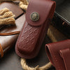 A dark brown genuine leather folding knife case with a brass emblem is shown next to natural twine.