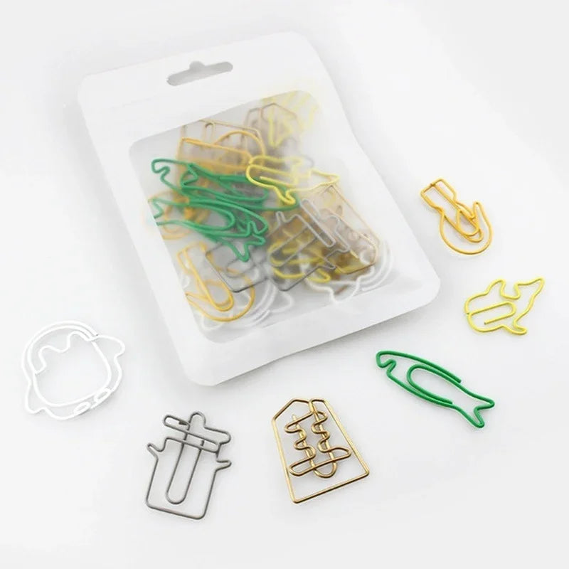 A clear plastic container holds various colorful decorative bookmarks made from paper clips.