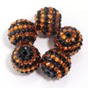 A set of five resin rhinestone beads with a two-tone orange and black striped design.