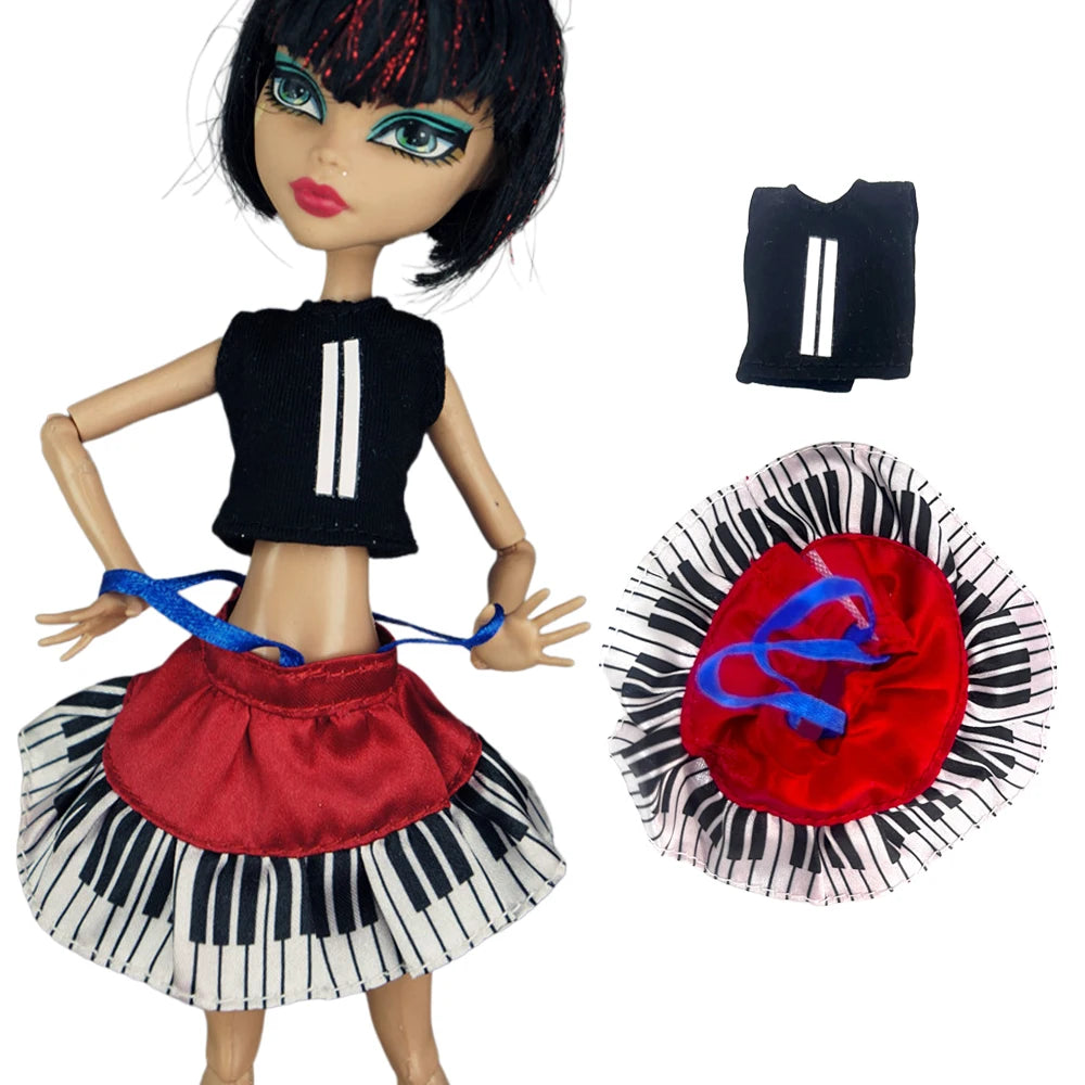 A fashion doll wearing a black and white striped skirt and top with a red ruffled collar and a black strap accessory.