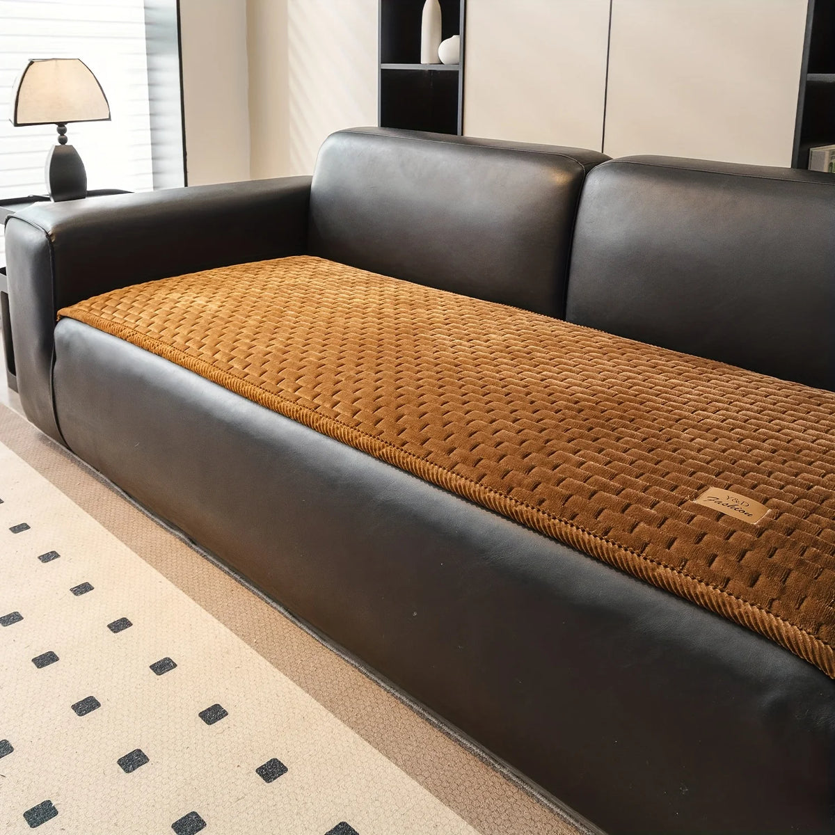 A dark brown quilted plush sofa cover with a textured tan cushion and non-slip backing.