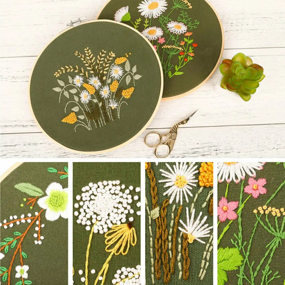 A set of floral cross stitch embroidery designs on fabric, including a circular piece and various plant motifs.