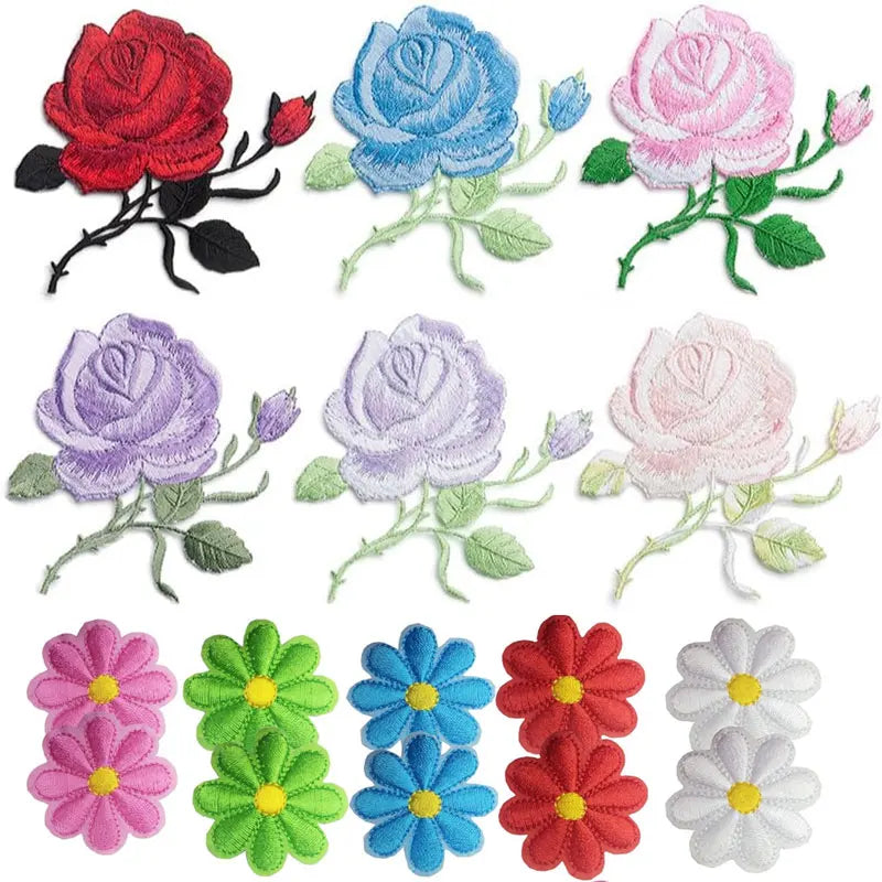 A collection of colorful embroidered iron-on patches featuring various shades of pink, purple, red, and blue roses.