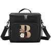 Black insulated canvas lunch bag with a large gold letter B and adjustable straps