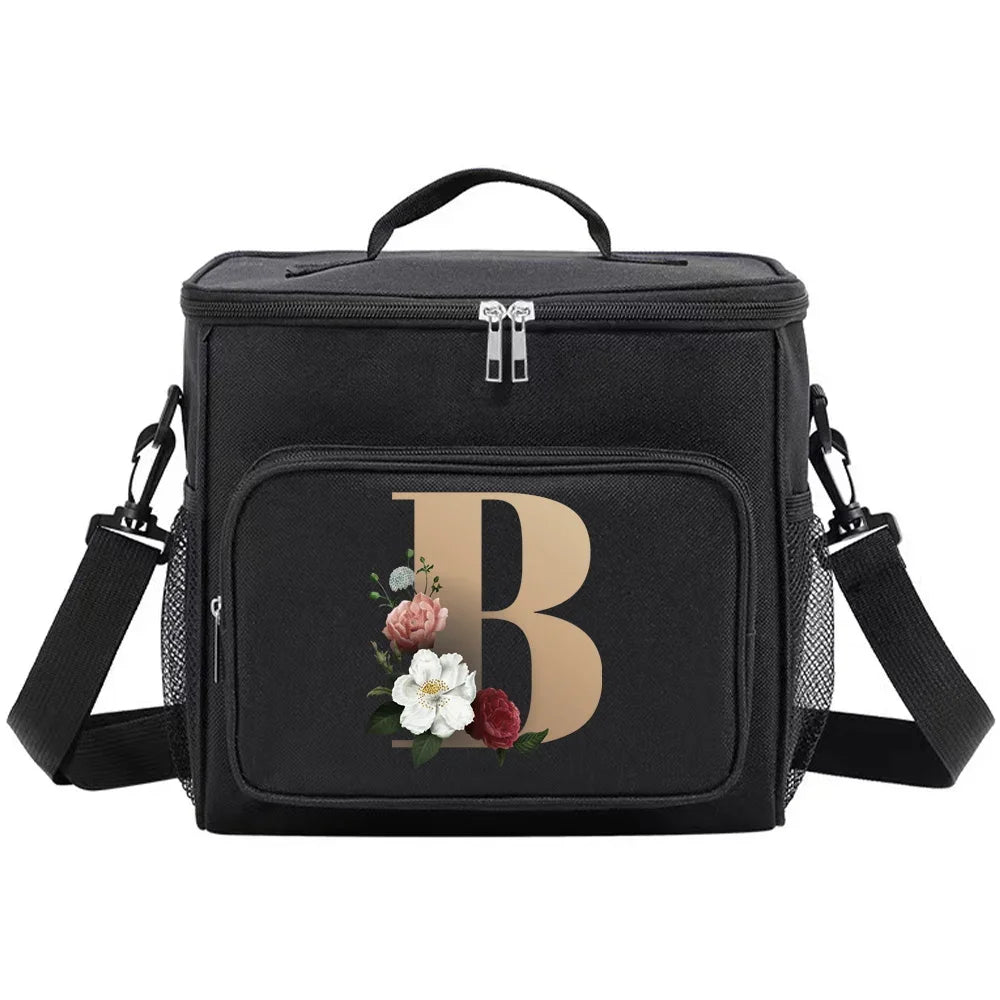 Black insulated canvas lunch bag with a large gold letter B and adjustable straps
