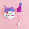A purple pet birthday party hat and bib set for cats and small dogs with a white cord.