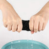 Hands dripping water onto a teal plate, demonstrating the mesh crochet hair net for sleeping and everyday wear.