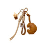 A braided leather croissant keychain featuring a bag pendant and a small glass charm.