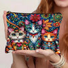 A hand holds a colorful canvas charger storage pouch featuring detailed feline designs in vibrant floral patterns.