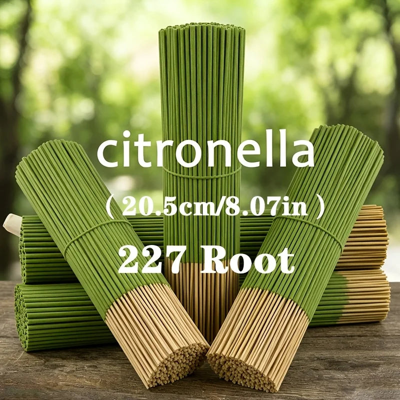 A stack of green citronella incense sticks and root material on a wooden surface.
