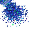 A pile of shiny holographic star sequins in various shades of blue and green.