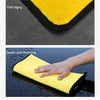 Close-up of yellow microfiber car cleaning towels showing fluff edging and double color thickening.