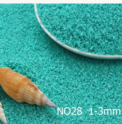 A small, light brown seashell is placed on a turquoise surface next to a measuring tool.