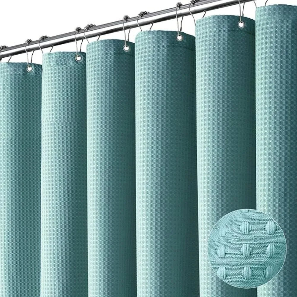 A set of vertical, waffle-textured, teal shower curtains hanging from a metal rod.
