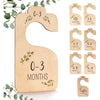 A set of eight wooden baby closet dividers for organizing clothes, ranging in size from newborn to 24 months.
