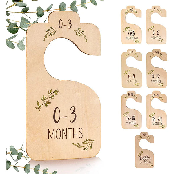 A set of eight wooden baby closet dividers for organizing clothes, ranging in size from newborn to 24 months.