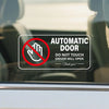 A warning decal on a car window prohibiting touching the driver when the automatic door is open.