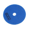 A blue felt polishing pad with the number 6000 visible on its surface.