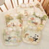 A set of soft cotton waterproof baby bibs with adjustable necks featuring cute animal designs and floral patterns.