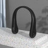 A black hands-free bladeless neck fan with a digital display is shown resting on a white surface.
