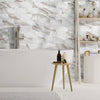 White marble self-adhesive wall tiles used as a backsplash in a modern bathroom setting.