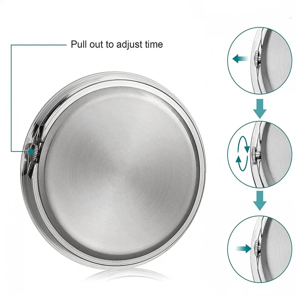 A silver mini car vent quartz clock with luminous hands shown being adjusted by pulling out a mechanism.