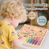 A young child is playing a magnetic maze logic puzzle board designed to teach color and quantity recognition.