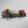 A black wall mounted tool storage rack holding various orange, red, and black-handled tools.