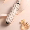 A beige automatic compact folding umbrella is shown next to its product packaging.