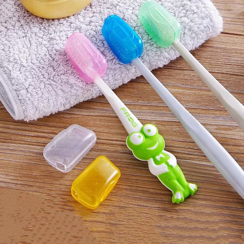 A set of colorful protective toothbrush heads and a travel clip resting on a gray towel and wooden surface.