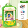A green mini claw crane machine for kids with lights and music, featuring various plush toys and a green frog.