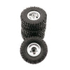 A stack of four black off-road RC car upgrade wheels with metal rims and soft tires