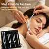 A woman is receiving gentle ear care with a tuning fork placed on her ear for relaxation.