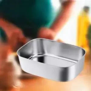 A silver portable electric lunch box is shown in a close-up shot with blurred hands and a bright background.