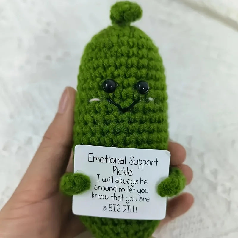 Handcrafted pickle plush toy with a green fuzzy body and a black muppet face