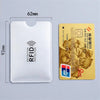 A white plastic card holder with an RFID protection feature next to a gold-colored ATM debit card.