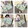 A light mint green waterproof travel duffle bag with a shoe compartment shown in various angles.