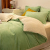 A light green flannel duvet cover with beige accents and a yellow pillow on a bed.