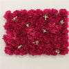 A dense wall panel of deep magenta silk rose flowers used for weddings and events.